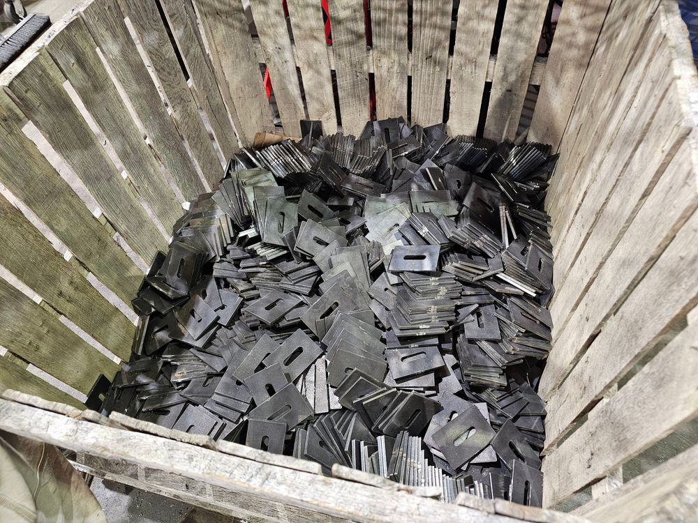 Crate of production-run plasma cut slotted plates